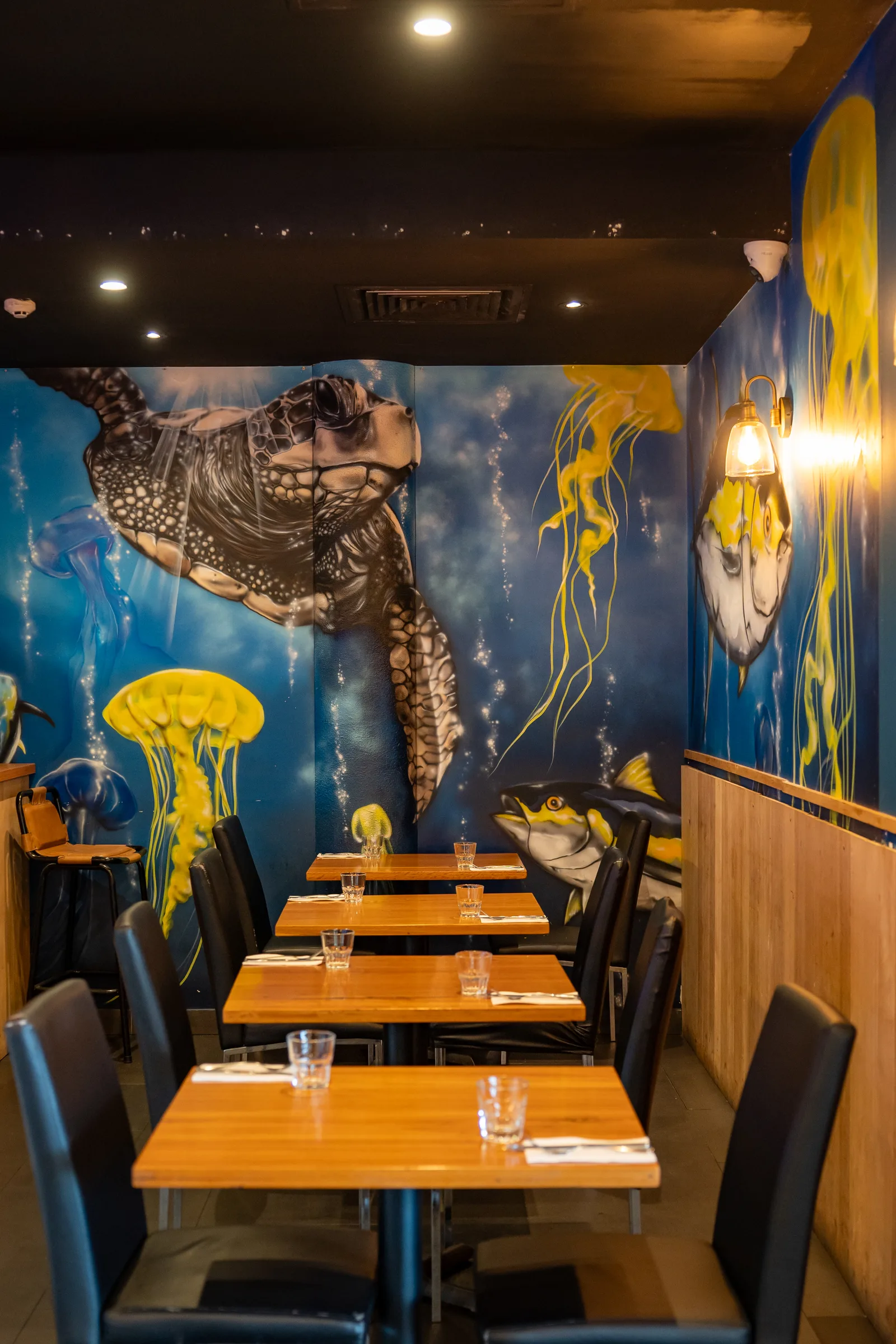 The intimate dining room at Sage Yellowfin South Bank Brisbane with ocean mural